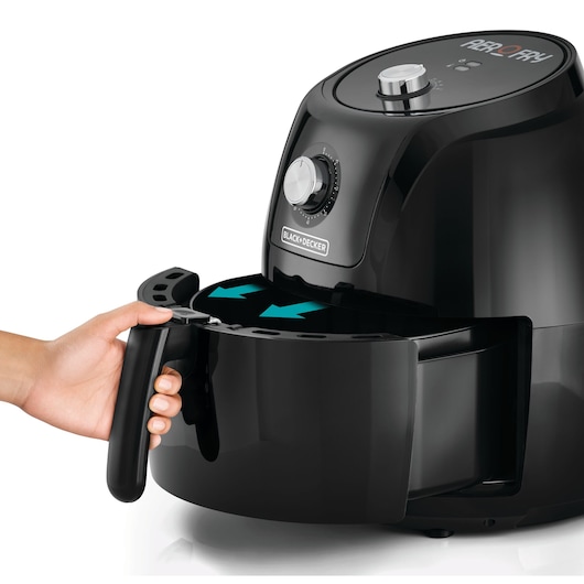 BLACKDECKER AF575 air fryer in black, side angle, hand pulling out basket.