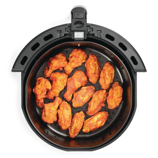 BLACKDECKER AF575 air fryer top view with cooked chicken wings inside, on white background.