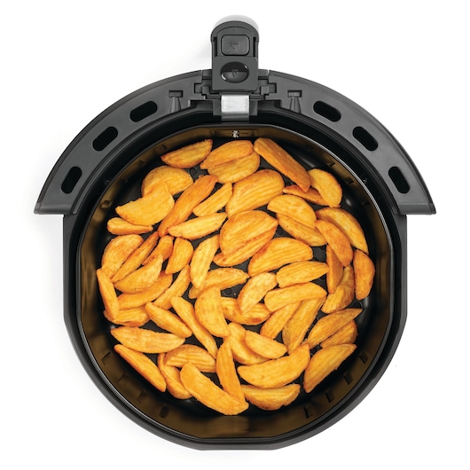 BLACKDECKER AF575 air fryer basket top view with crispy potato wedges inside, white background.