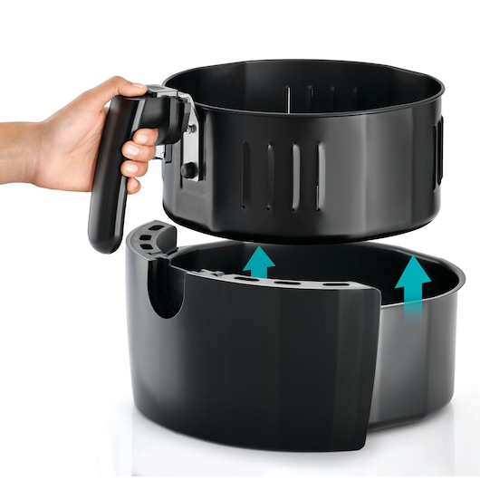 BLACKDECKER AF625 air fryer basket being lifted from base, black finish, hand holding handle, white background.