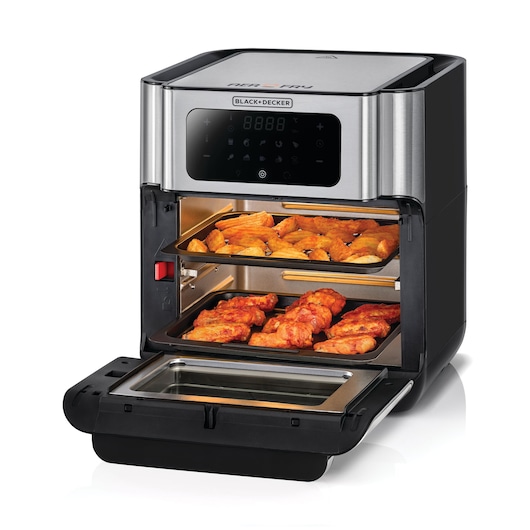 A BLACK+DECKER air fryer oven with digital control panel, shown with its door open and two trays of cooked food inside, including what appears to be chicken wings and fries.