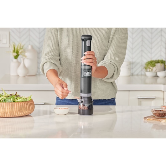 BLACKDECKER electric salt and pepper grinder BCKM1016KSB in use on kitchen counter, modern setting.