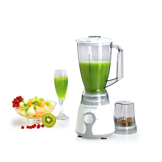 A BLACK+DECKER BX225 blender with a transparent jar filled with green juice, accompanied by a small grinder attachment, a glass of green juice, and a bowl of mixed fresh fruits including kiwi, melon, and red currants.