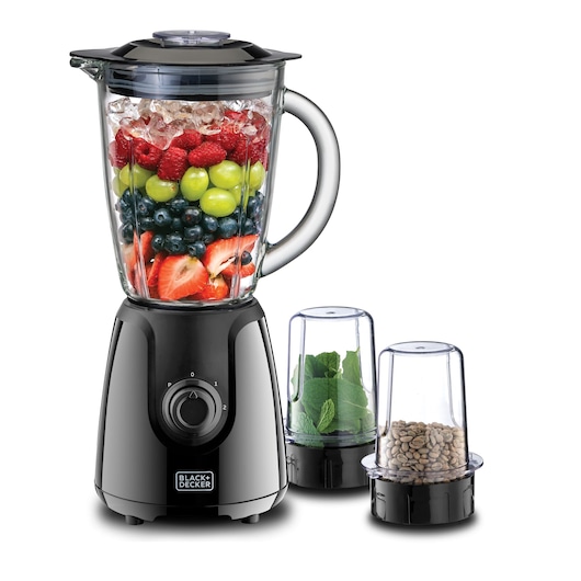 A BLACK+DECKER blender with a glass jar filled with ice cubes, strawberries, blueberries, grapes, and raspberries, accompanied by two smaller containers, one with green leaves and one with coffee beans.