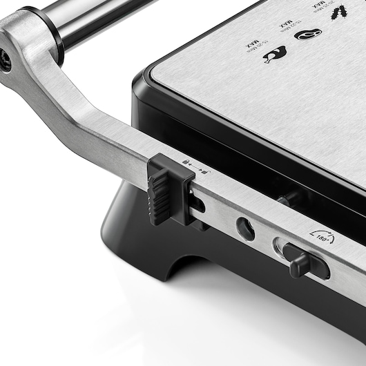 BLACKDECKER CG1400 grill close-up, showing stainless steel handle, control switch, and icons on top plate, angled view.
