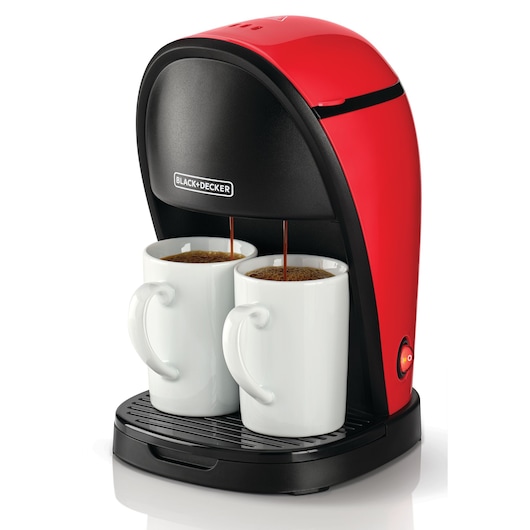 A red and black BLACK+DECKER coffee maker brewing coffee into two white mugs placed on its drip tray.