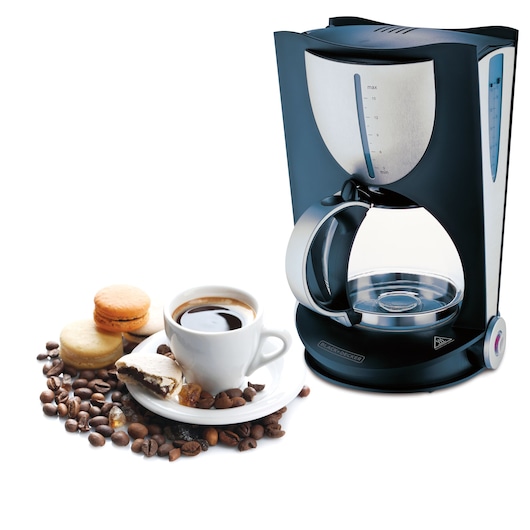 A BLACK+DECKER drip coffee maker with a glass carafe, next to a white cup of coffee on a saucer surrounded by coffee beans and assorted pastries.