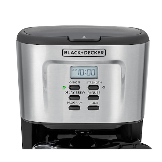 Front view of a BLACK+DECKER coffee maker featuring a digital clock display and several buttons for functions such as On/Off, Strength, Delay Brew, Minute, Program, and Hour. The machine has a stainless steel finish with a black top.