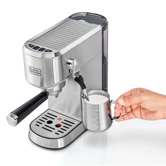 BLACKDECKER ECM150 espresso machine side view steaming milk in metal frothing pitcher.