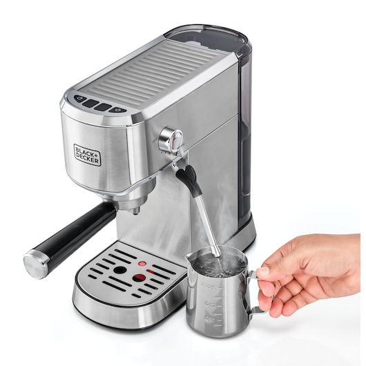 BLACK+DECKER ECM150 espresso machine side view with steam wand frothing milk in metal pitcher.