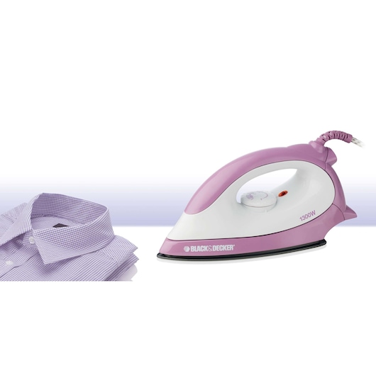 A pink and white BLACK+DECKER electric iron is placed next to a neatly folded, light purple dress shirt.