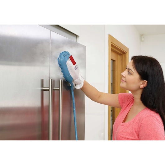BLACKDECKER FSH10SM steam cleaning glove in use on stainless steel refrigerator door.