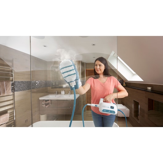 BLACKDECKER FSH10SM steam cleaning glove in use on glass shower door in modern bathroom.