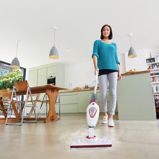 Photo of BLACKDECKER FSM1605R steam mop cleaning tiled floor in modern kitchen setting.