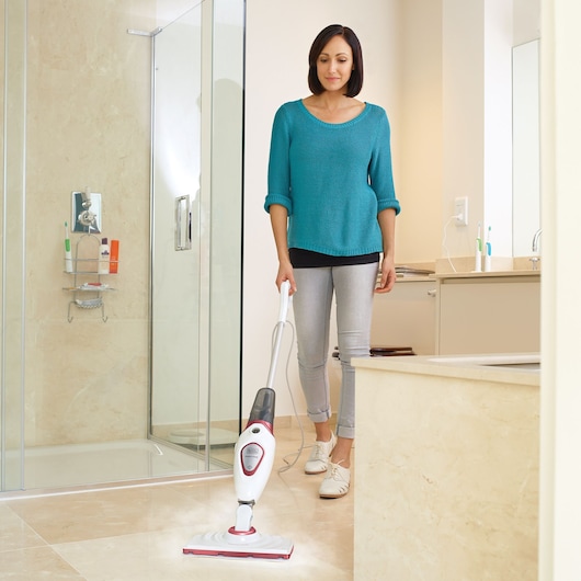 BLACKDECKER FSM1605R steam mop in use on bathroom tile floor, showing front view in home setting.