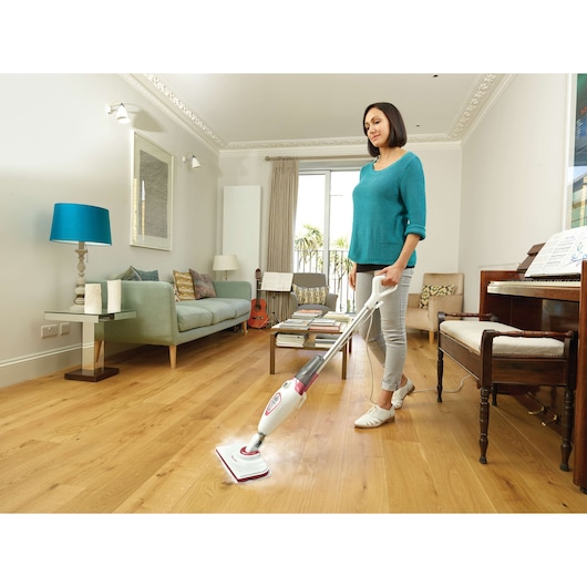 BLACKDECKER FSM1605R steam mop cleaning hardwood floor in bright living room.