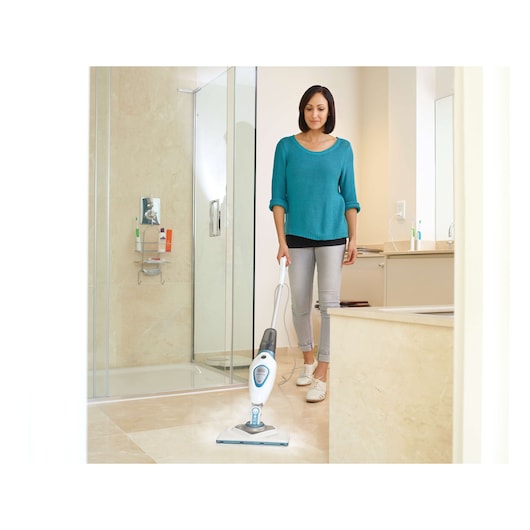 BLACKDECKER FSM1616 steam mop cleaning bathroom floor, person operating the device.