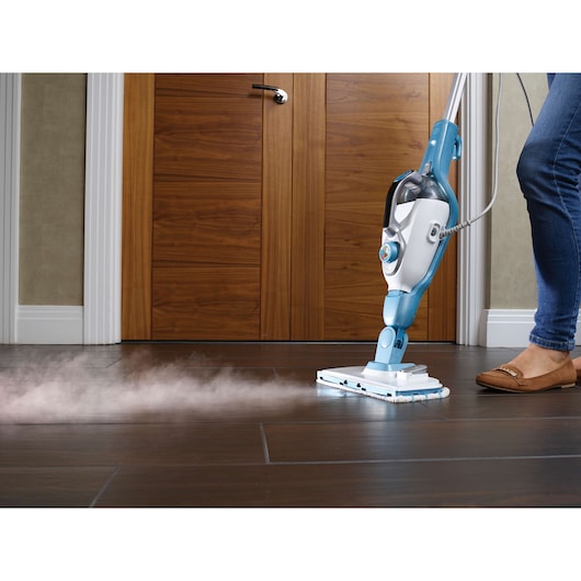 BLACKDECKER FSMH13151SM steam mop cleaning dark tile floor, side view.