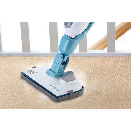 BLACKDECKER FSMH13151SM steam mop base on beige carpet, close-up photography of cleaning appliance.
