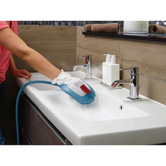 BLACKDECKER FSMH13151SM steam cleaning glove used on white bathroom sink, product photography.