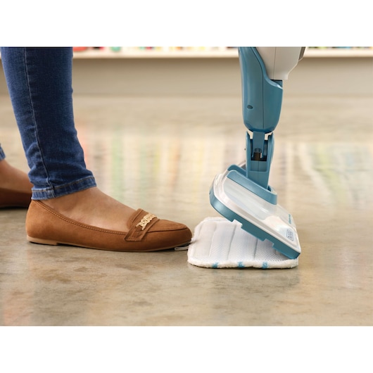 BLACKDECKER FSMH13151SM steam mop with white cleaning pad on floor, side angle.