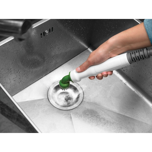 Photo of BLACKDECKER FSMH13151SM handheld cleaning tool scrubbing a stainless steel sink drain.