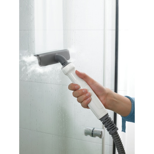 BLACKDECKER FSMH13151SM steam cleaner cleaning glass shower with white handle and gray nozzle, side angle