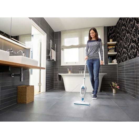 BLACKDECKER FSMH13E10 steam mop in use cleaning bathroom tile floor.