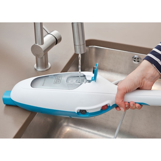 Photo of BLACKDECKER FSMH13E10 steam mop being filled with water at a sink, close-up of water tank.