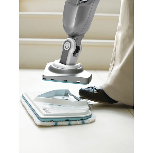 BLACKDECKER FSMP30 floor steam mop pad replacement being attached, close-up of foot and mop head.
