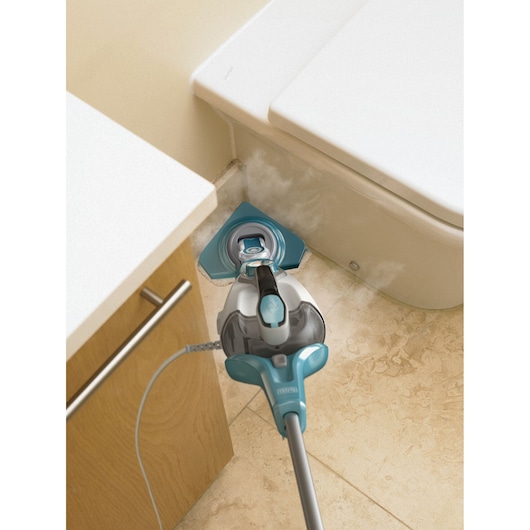 BLACKDECKER FSMP30 steam mop cleaning tile floor corner near toilet and cabinet.