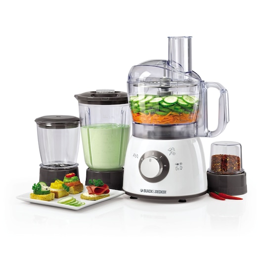 BLACK+DECKER FX400BMG food processor set including main food processor with sliced vegetables, blender jar with green smoothie, grinder jar with spices, and a plate with assorted snacks, all placed on a white surface.