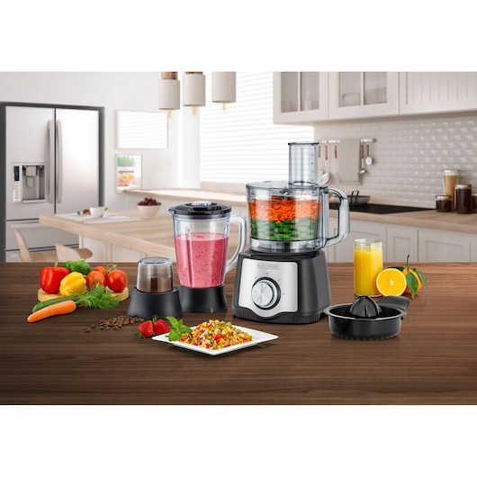 Photo of BLACK+DECKER FX650 food processor with blender, grinder, and citrus juicer attachments on a kitchen counter.