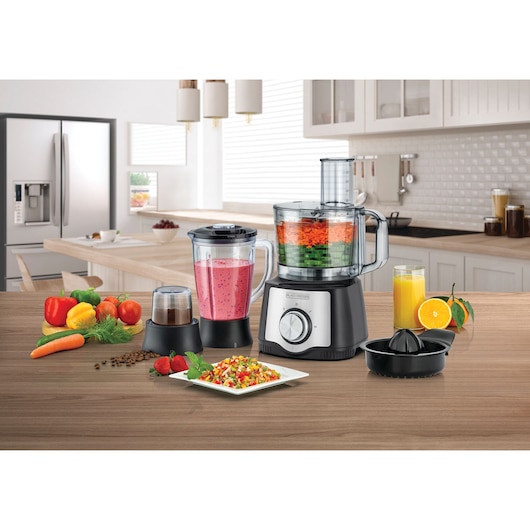 BLACKDECKER FX650 food processor set with blender, grinder, and citrus juicer on kitchen counter, fruits and vegetables beside.