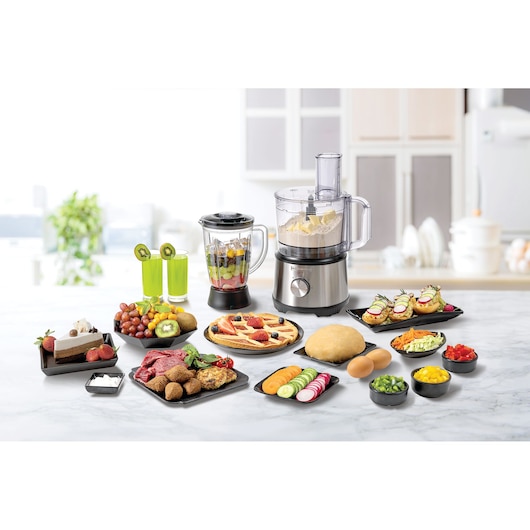 BLACKDECKER FX825 food processor and blender on kitchen counter with assorted prepared foods and ingredients, front angle.