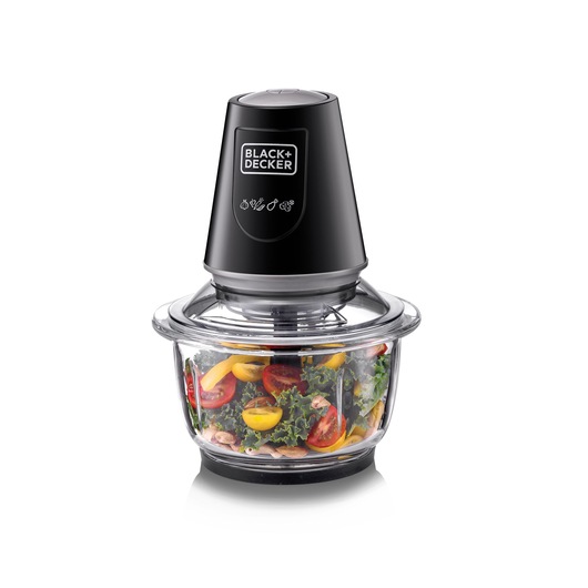 A BLACK+DECKER food chopper with a black lid and transparent glass bowl containing chopped vegetables, including tomatoes and greens, on a white background.