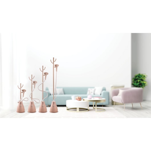 BLACKDECKER GST1620 garment steamers in soft pink shown in different heights, placed in a modern living room.