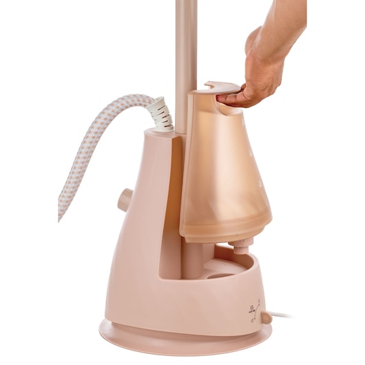 BLACKDECKER GST1620 garment steamer with hand removing water tank, side angle, white background.