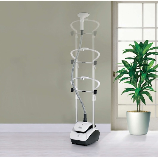 BLACKDECKER GST2000 garment steamer in white and black, upright with adjustable frame, shown in a modern room.