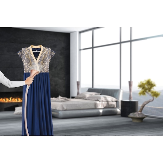 BLACKDECKER GSTD2050 garment steamer used on a blue and gold dress in a modern bedroom.