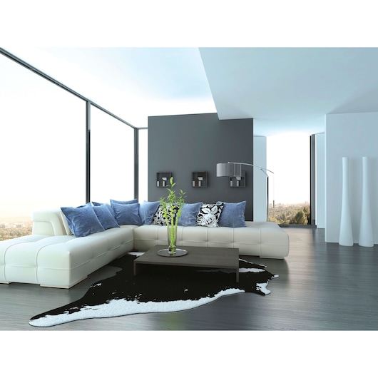 BLACKDECKER HX230 modern living room photography with white sectional sofa, blue and patterned pillows, large windows.