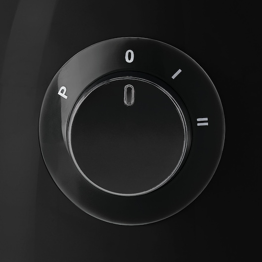 BLACK+DECKER KR42 black control dial with white settings on glossy surface, close-up angle.