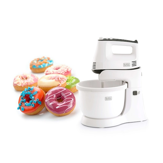 A BLACK+DECKER stand mixer model M700 in white, placed next to several colorful decorated donuts.
