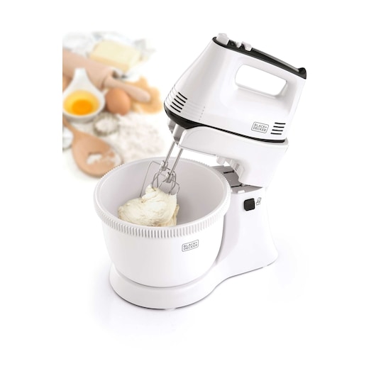 BLACKDECKER M700 white stand mixer with mixing bowl, photographed at front angle with baking ingredients in background.