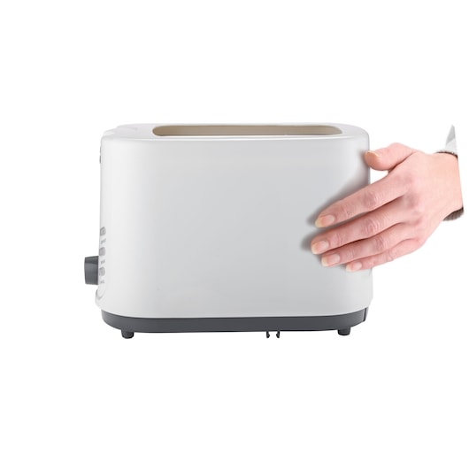 BLACKDECKER MBF70 white toaster side view with hand touching the side, photo on white background.