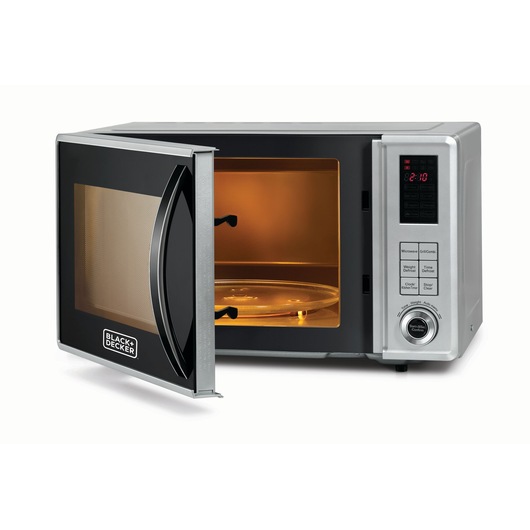 A BLACK+DECKER microwave oven with a silver and black finish, shown with the door open and the interior illuminated. The control panel features a digital display and multiple buttons.