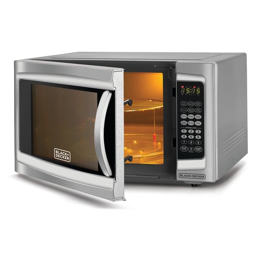 A BLACK+DECKER microwave oven with a silver finish, shown with the door open to display the illuminated interior, glass turntable, and digital control panel.