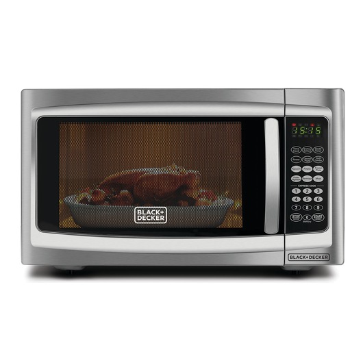 Photo of BLACK+DECKER MZ42PGSA microwave oven, front view, with cooked food inside and digital control panel.