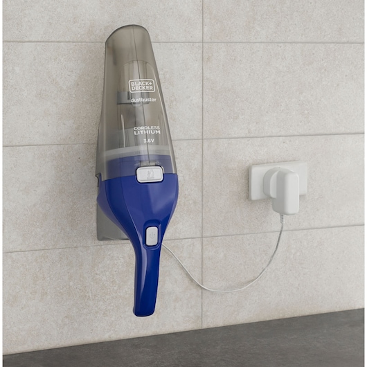 BLACK+DECKER NVC115WA handheld cordless vacuum mounted and charging on tiled wall.