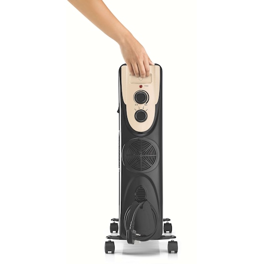 BLACKDECKER OR011FD oil-filled radiator heater with beige control panel, power dials, and hand adjusting settings, front view.